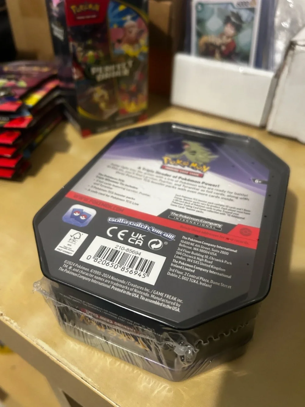 Pokemon Tin Featuring Green Tyranitar on Blue and Purple Artwork